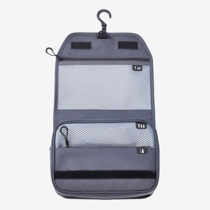 Gray travel organizer with mesh pockets and hanging hook on a white background