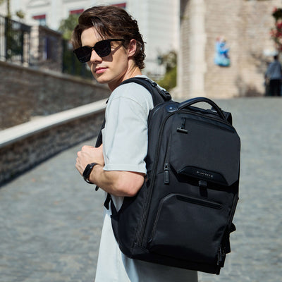 Male model wearing Nayo Smart Almighty A1 black business travel backpack city street lifestyle shot