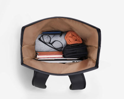 Top-down open main compartment of NayoSmart Urban U8 black roll-top backpack, internal organization with laptop sleeve and mesh pockets