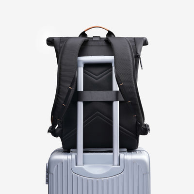 NayoSmart Urban U8 black roll-top backpack mounted on suitcase handle, built-in luggage trolley sleeve for travel