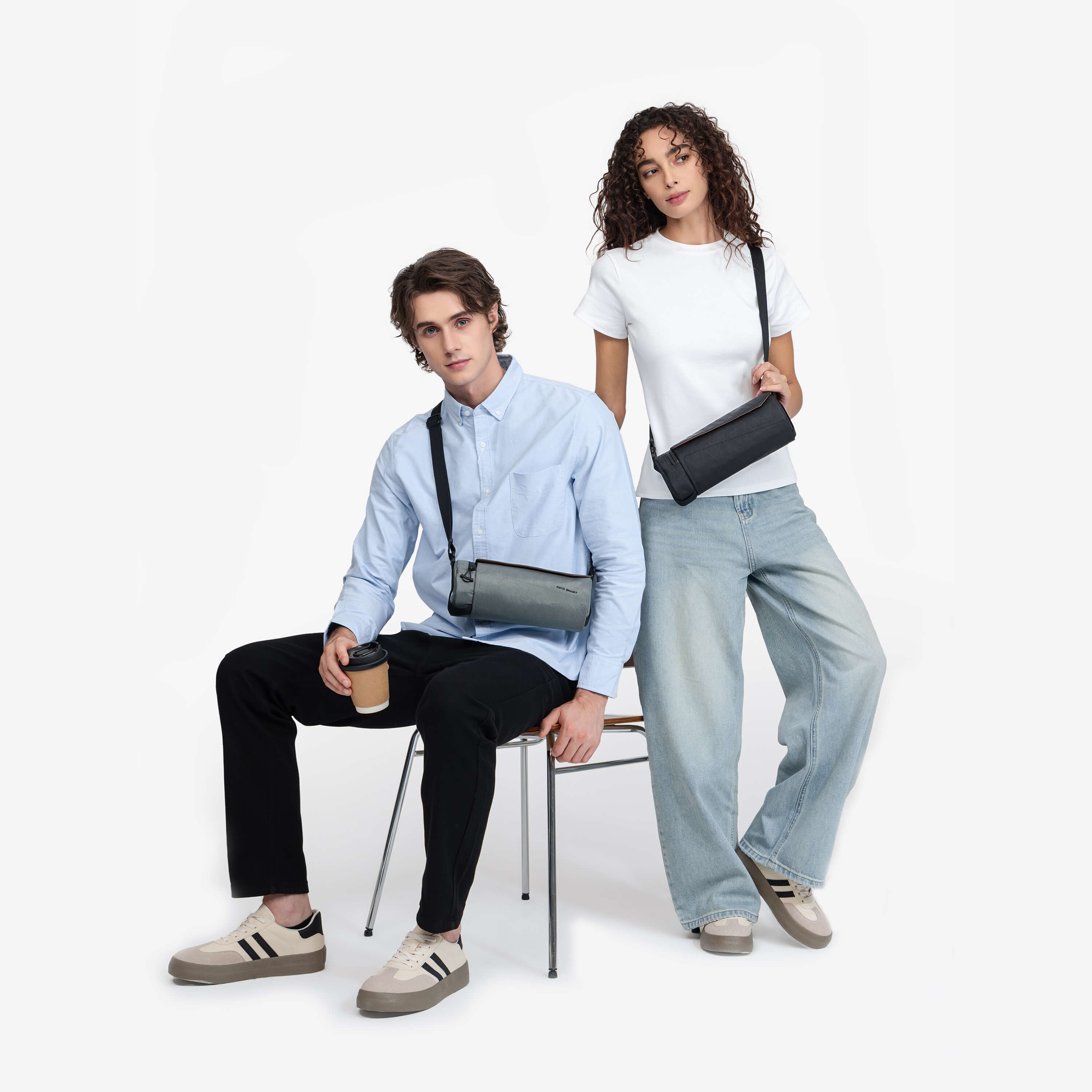Nayo Smart Urban UL5 Cylinder Sling Bag Graphite, male and female model wearing graphite crossbody sling bag indoor