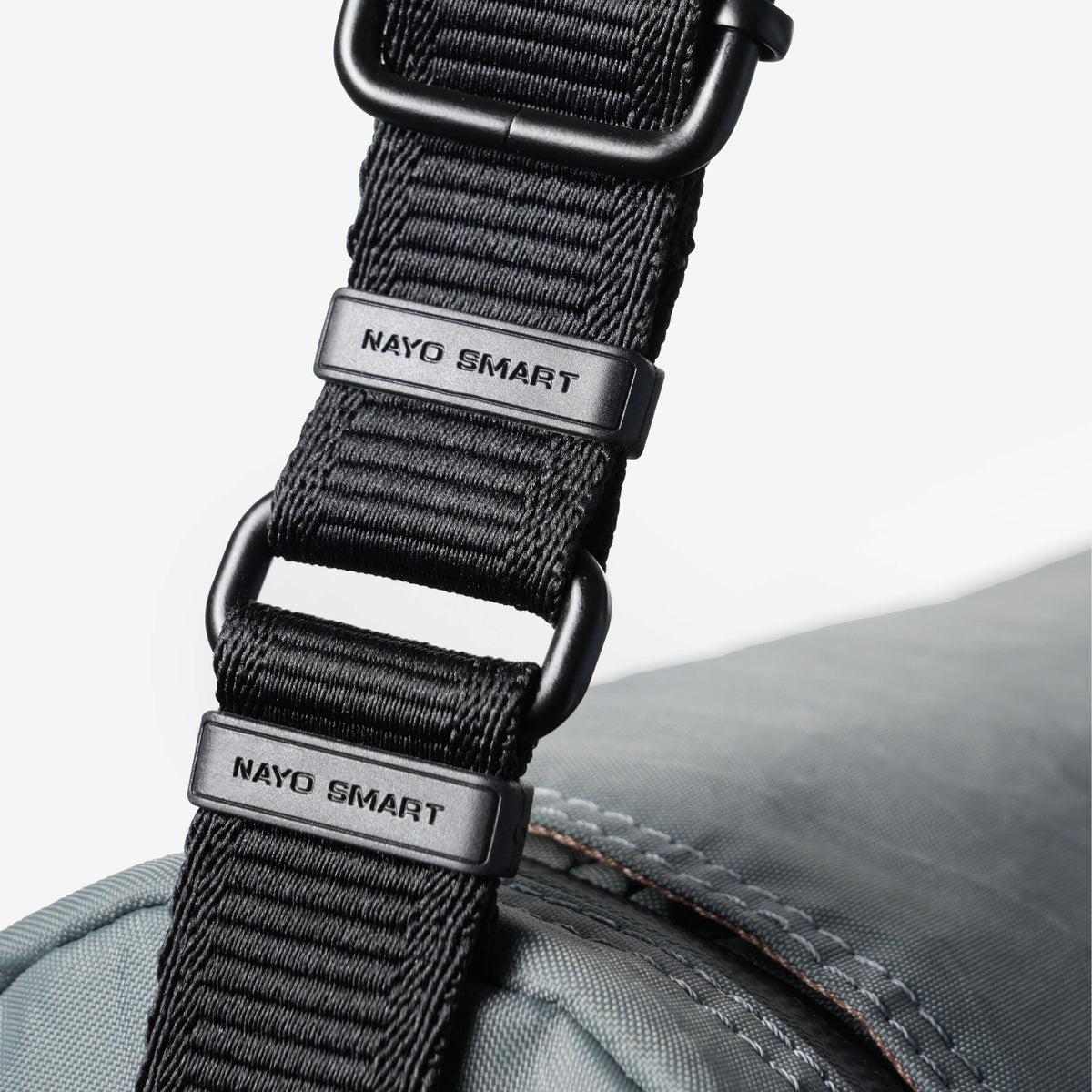 Nayo Smart Urban UL5 Cylindrical Sling Bag (Graphite Grey) — Close-up of branded webbing and metal hardware.