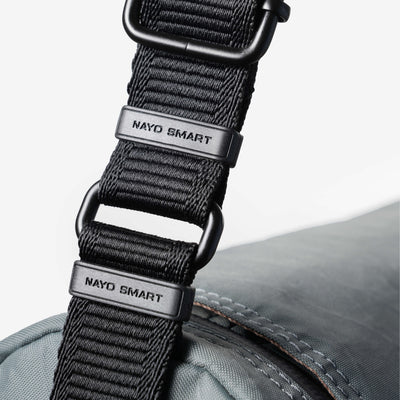 Nayo Smart Urban UL5 Cylindrical Sling Bag (Graphite Grey) — Close-up of branded webbing and metal hardware.