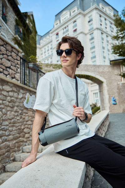 Nayo Smart Urban UL5 Cylinder Sling Bag Graphite, male model outdoor street wearing graphite cylinder sling bag
