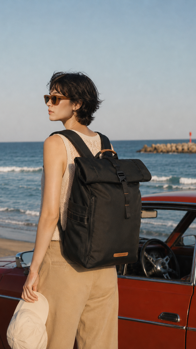 NayoSmart Urban U8 black roll‑top backpack, female model back view at seaside with vintage car, travel vacation lifestyle unisex roll‑top rucksack
