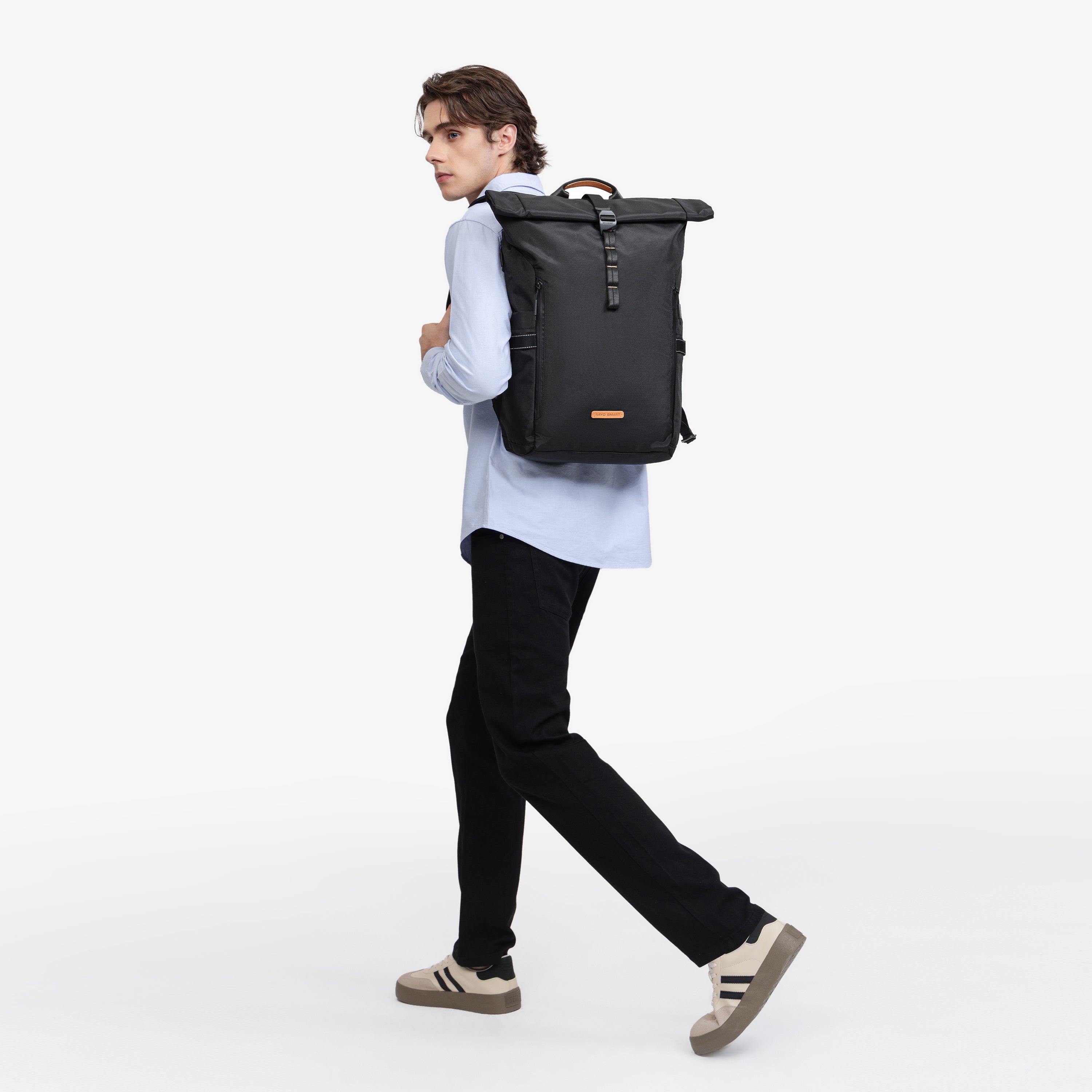 NayoSmart Urban U8 black roll‑top backpack, male model walking dynamic wearing side view on white background, show shoulder strap comfort for daily commute