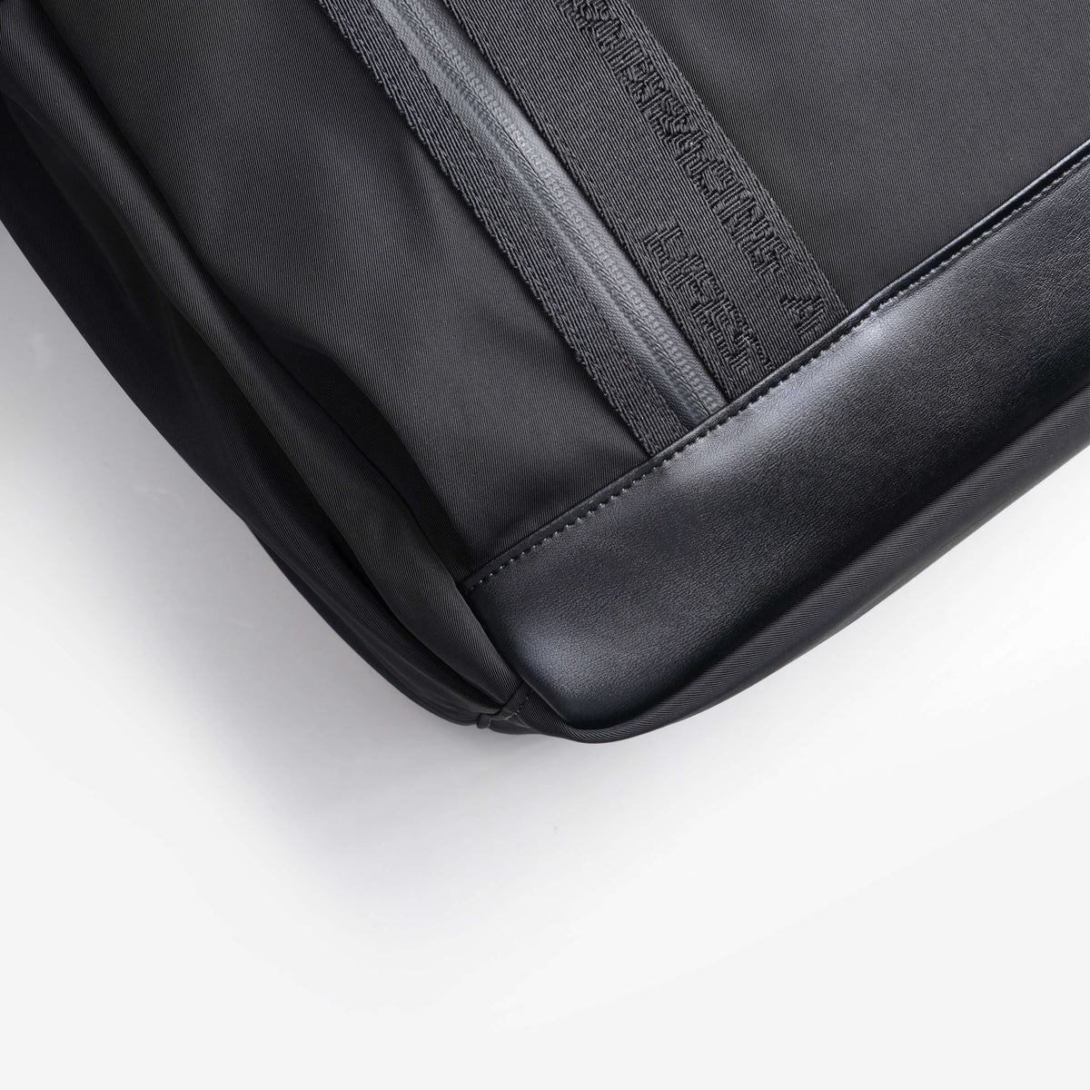 NayoSmart Urban U9 roll‑top backpack black fabric close‑up, durable water‑resistant textile detail shot