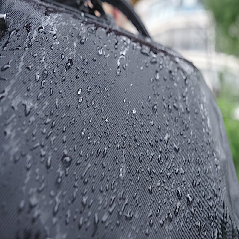 Nayo Smart Almighty A1 business travel backpack GIF demonstrating water‑resistant fabric with water beading on surface