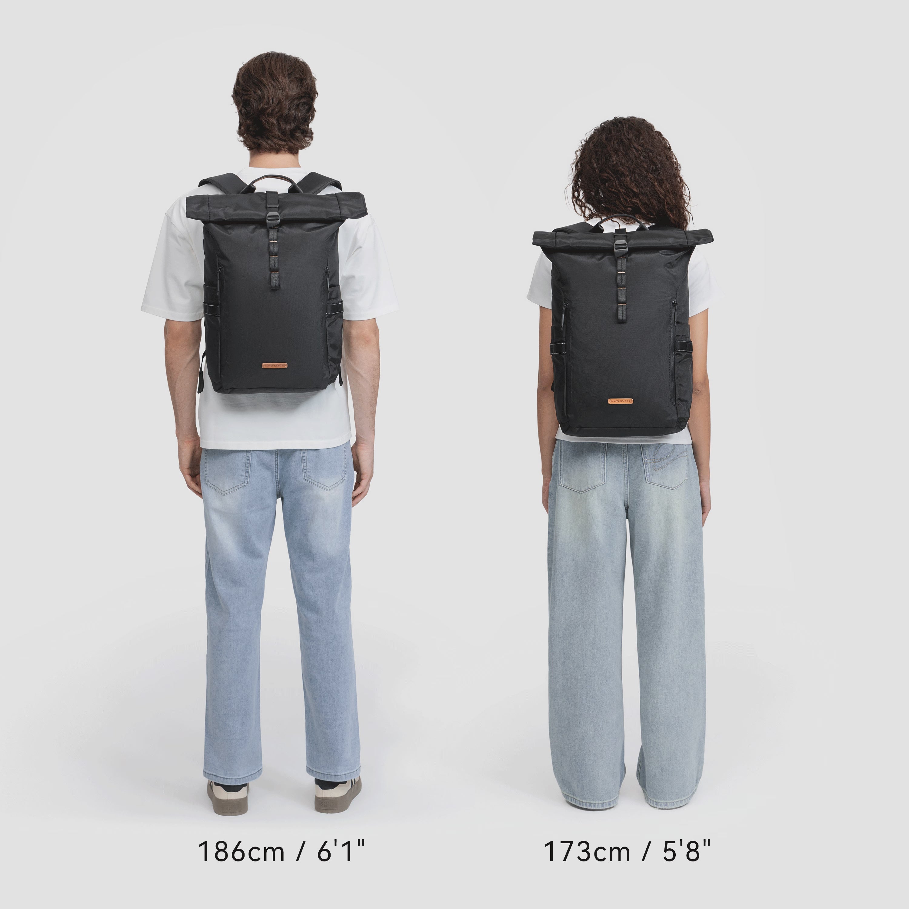 Man and woman modeling NayoSmart Urban U8 black roll‑top backpack, multiple carry fit demonstrations on white background, unisex commuter rucksack