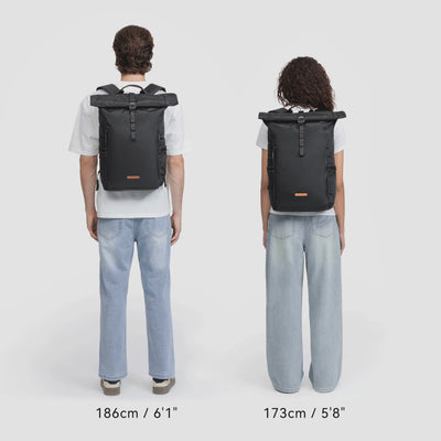 Man and woman modeling NayoSmart Urban U8 black roll‑top backpack, multiple carry fit demonstrations on white background, unisex commuter rucksack